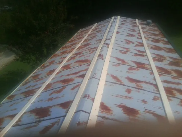Rusted metal roof panels with new wood purlins before replacement — Storm Damage Roof Repair in Beaumont by Roofing Brothers